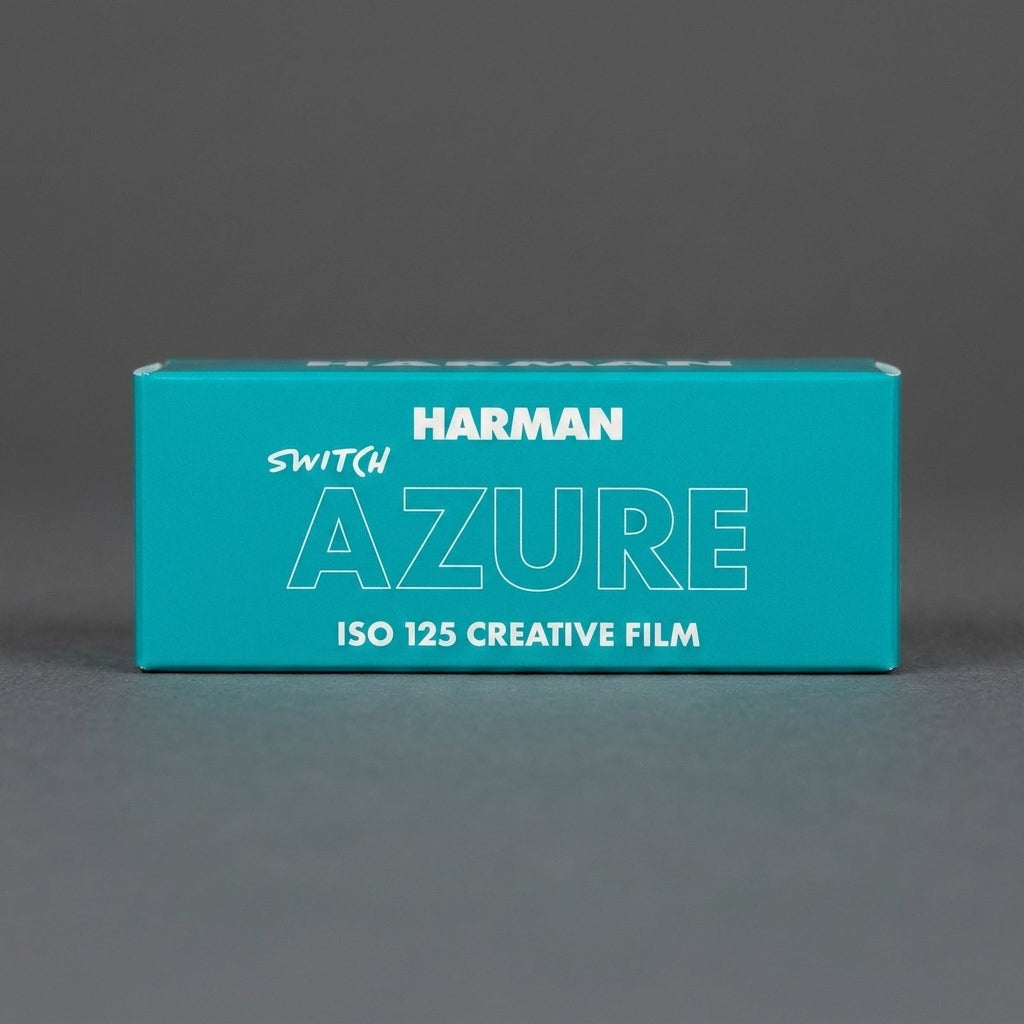 Teal Harman Switch Azure ISO 125 120 film box, front view on grey background