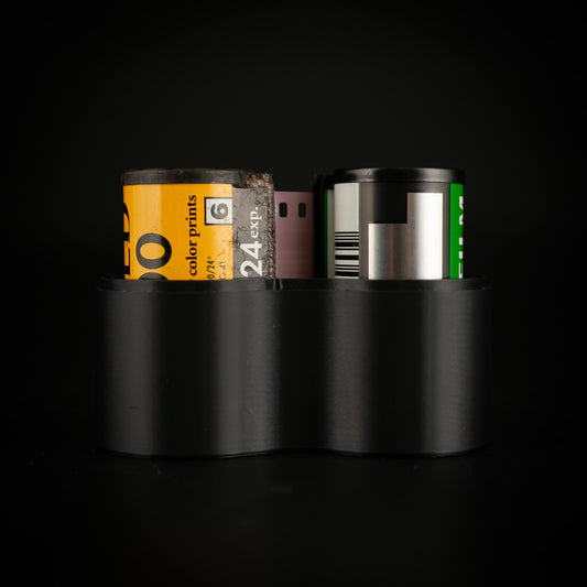 Respooling tool holding two 35mm film canisters side by side in its twin chambers