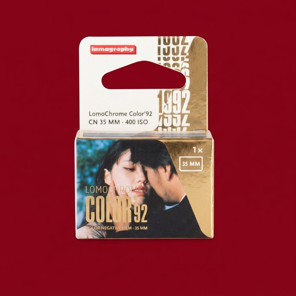 LomoChrome Color 92 35mm film box, gold packaging with couple on front, red background