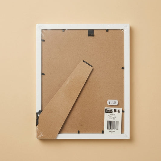 Back of the white Finny frame in packaging, showing MDF backing board, clips and price sticker