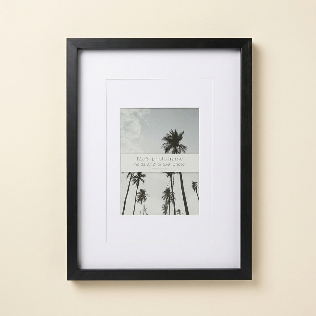 Black Escape 12x16 frame with white mat and palm tree insert on a wall