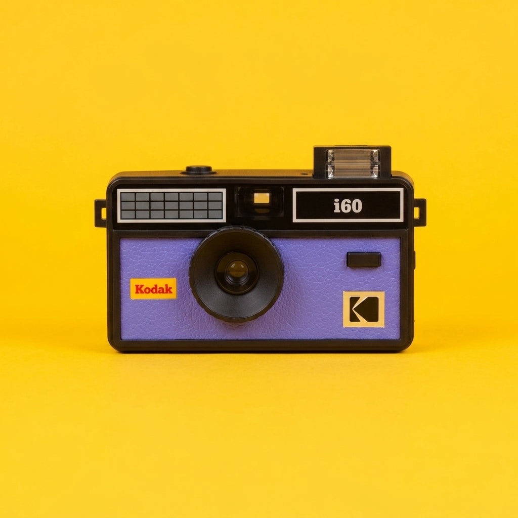 Kodak i60 camera in purple and black, front on, against a yellow background