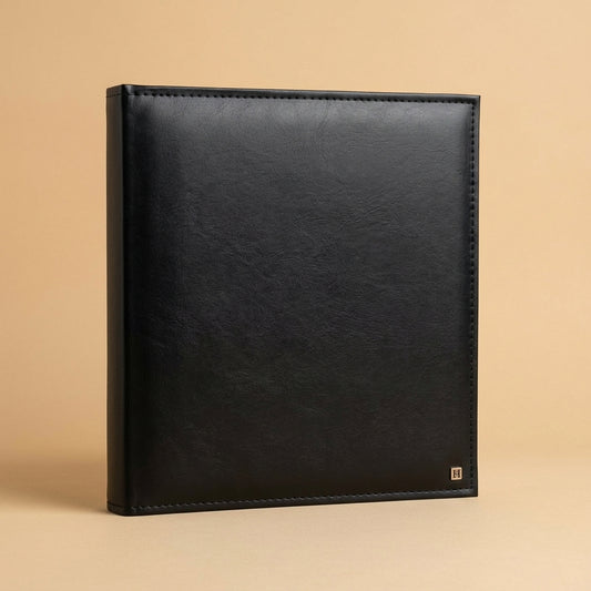 Henzo Lonzo album in black with stitched edges, standing at an angle on a beige background