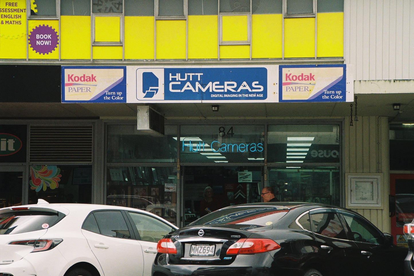Hutt Cameras store front with cars parked outside