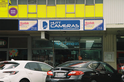 Hutt Cameras store front with cars parked outside
