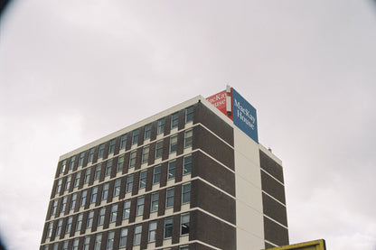 High-rise building with a Mackay House sign on a cloudy day