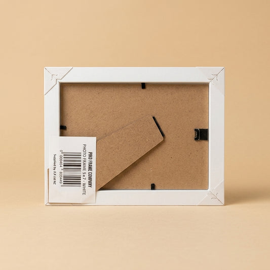 Back of white PIKO 5x7 frame showing board, easel stand and barcode label