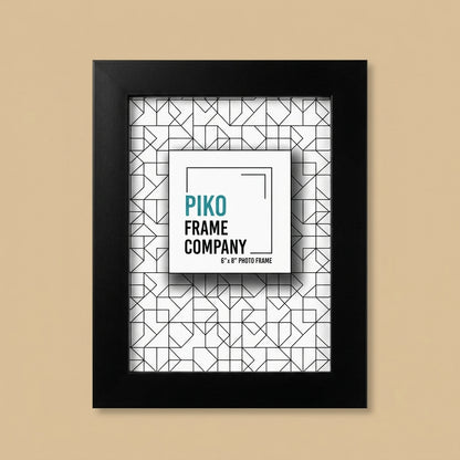 PIKO 6x8 black photo frame standing upright on a beige background with printed insert