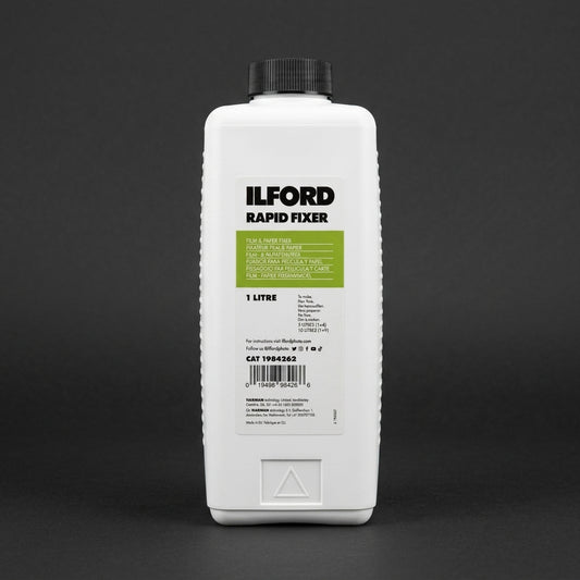 White 1 litre bottle of Ilford Rapid Fixer with green label on a grey background