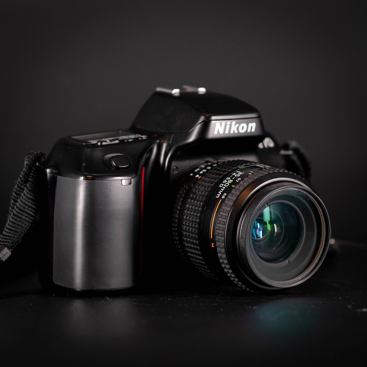 Nikon camera with lens on a dark background