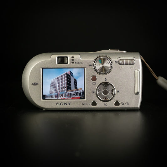 Silver Sony Cyber-shot DSC-P150 compact camera at an angle with lens extended, on black