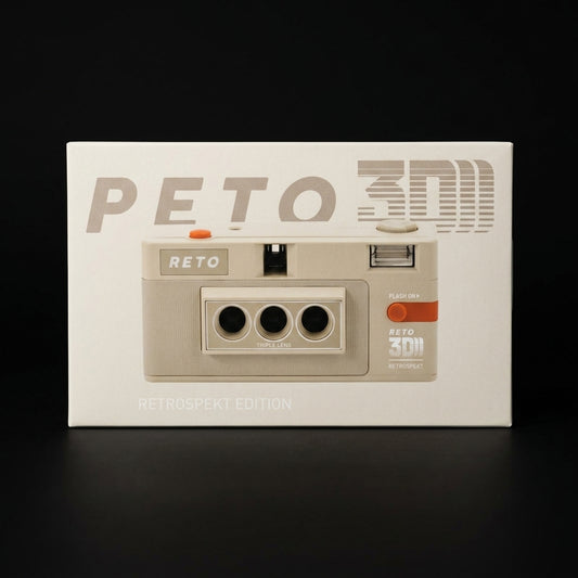Boxed Reto 3D camera, Retrospekt Edition, cream packaging on a dark surface