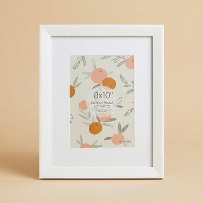 Finny 8x10 white photo frame with mat, printed insert, standing against a beige background