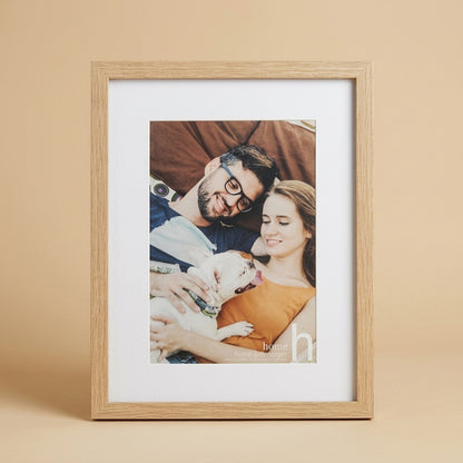 Light oak 12x16 inch frame with white mat and printed insert of a couple with a dog