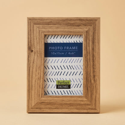 Westminster 6x4 photo frame in light brown woodgrain, standing on a beige background
