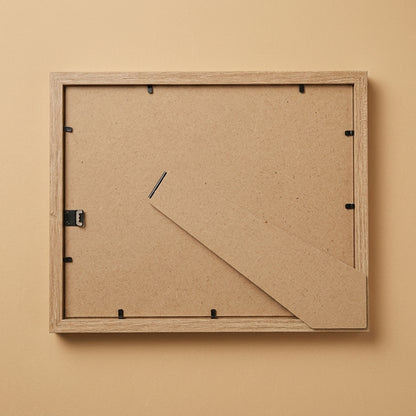 Back of the oak 8x10 frame showing MDF backing board, clips and easel stand