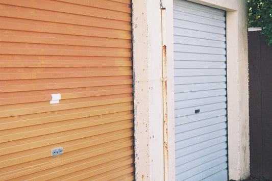 Sample shot: orange and pale blue roller doors on a concrete building