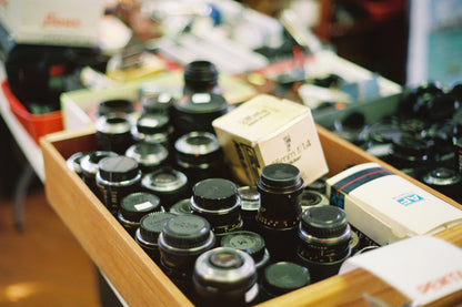 Collection of Camera lenses in a wooden box with blurred background