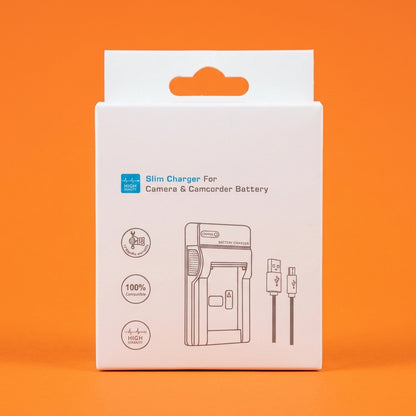 White boxed slim charger for camera batteries, standing on an orange background