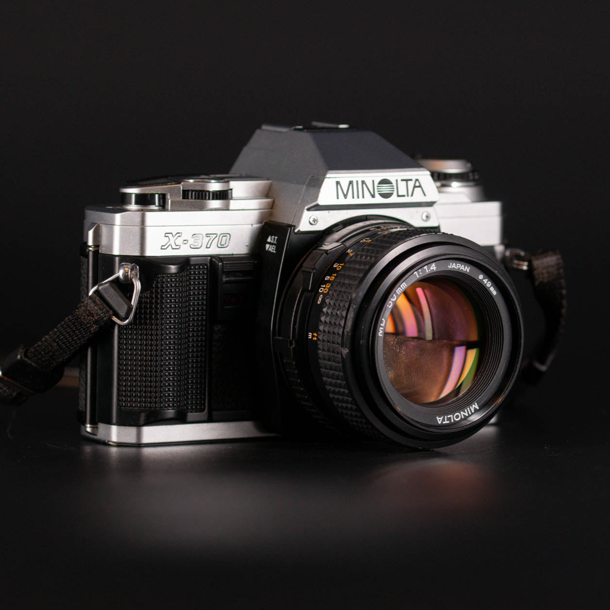 Minolta X-370 camera on a black background