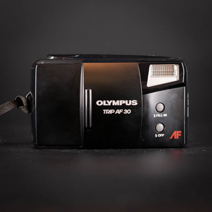 Vintage Olympus Trip AF 30 camera on a dark background